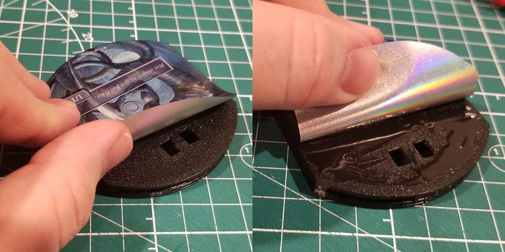 Peel back the top half of the label and apply super glue to the remaining portion of the Mass MTG Tokens shell