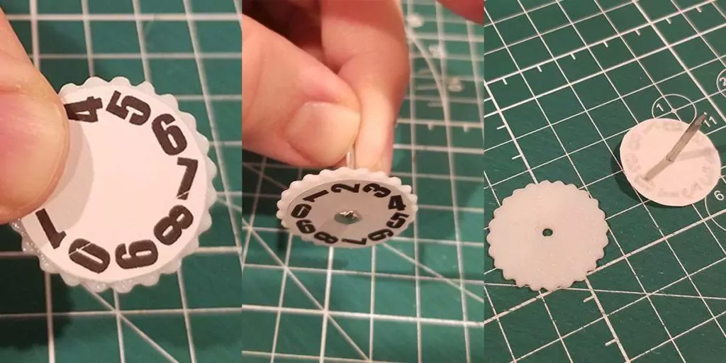Demonstrating the process of applying the number wheel cutouts to the 3D printed wheels for the Mass MTG Dry Erase Tokens.