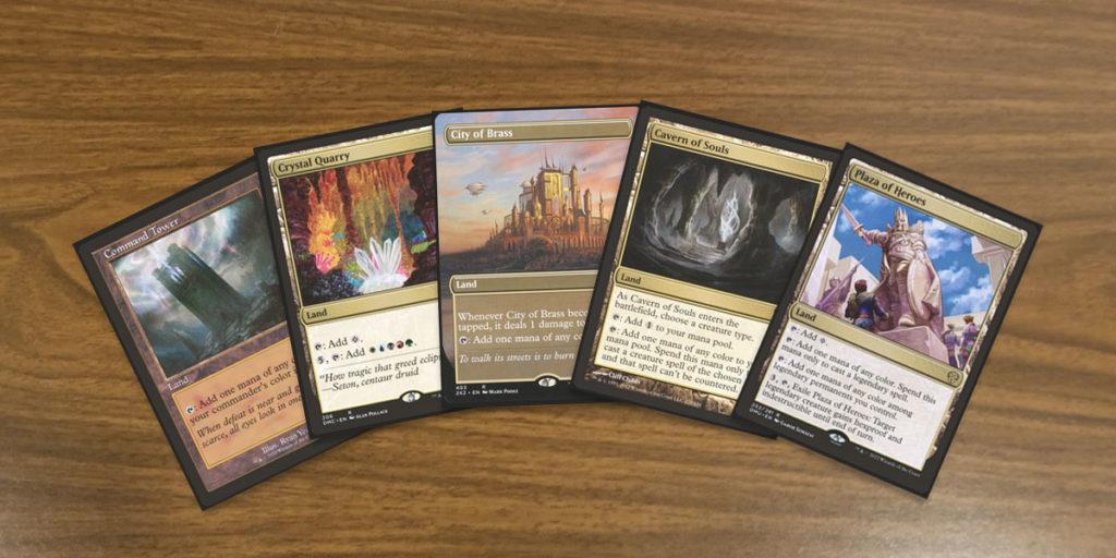 Five MTG land cards, Command Tower, Crystal Quarry, City of Brass, Cavern of Souls and Plaza of Heroes to represent the MTG 5 Color Lands Guide