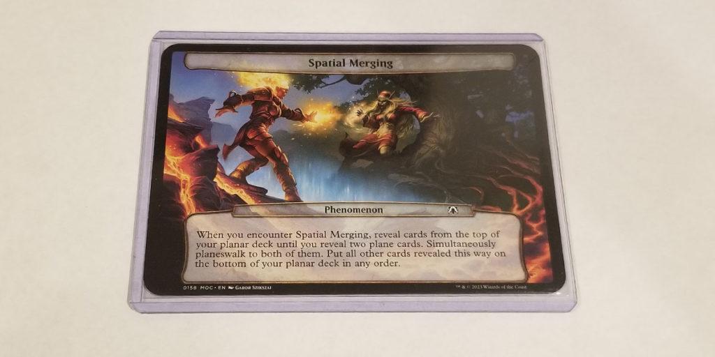 An image for the article 'Need Planechase Sleeves? MTG Oversized Sleeves & Top Loaders Reviewed!' showing a copy of Spatial Merging in an oversized sleeve and an oversized toploader.