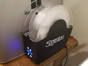 An essentail Bambu X1 Carbon upgrade is a filament dryer. Shown in the photo is the 3Dgenius filament dryer with transparent PETG being dried in it.