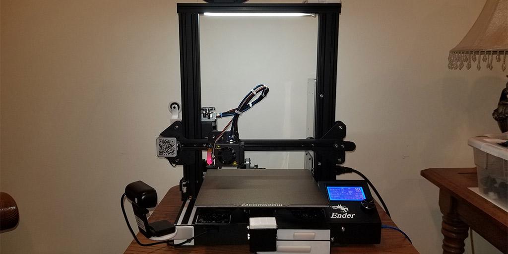 A photo of my Ender 3 Pro which I feel like is the best 3d printer for beginners. The Ender 3 Pro is shown with a lot of upgrades on it such as an LED kit, a webcam, tool drawers, filament guide, all metal extruder, PEI build plate, and more.