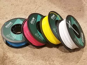 This photo shows 4 spools of PLA in the specific colors need to 3D print a color lithophane to create a 3D printed lithophane lamp. The specific colors needed are cyan, magenta, yellow and white. These are eSun brand spools.