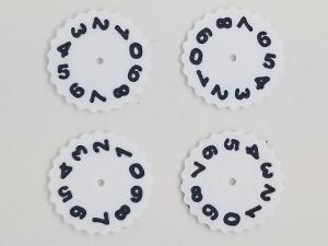 A photo showing 4x dual colored number wheels for the Mass MTG Dry Erase Tokens. The wheel is white and the numbers are black.