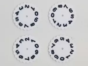 A photo showing 4x dual colored number wheels for the Mass MTG Tokens. The wheel is white and the numbers are black.