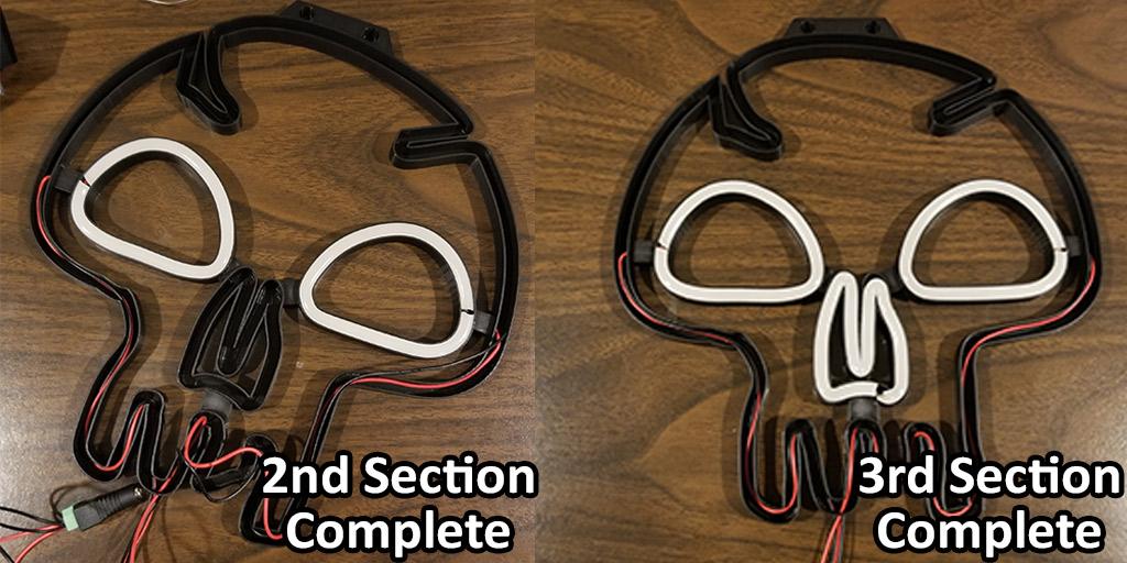 This image shows the 3D printed light with the second section of LED strips completed on the left, and the third section of LED strips completed on the right. The fourth section of LED strips needs to be completed and all the wiring will be finished on this 3D printed neon sign.