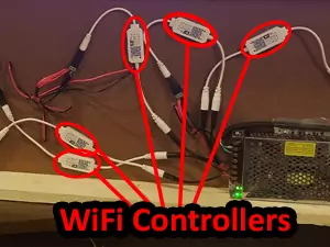 An image showing the wiring for a 3D printed neon sign with 5 individual 3D printed light pieces with a WiFi controller hooked up to each one. Each controller is circled in red and pointing to the text 'WiFi Controllers' which is also in red.