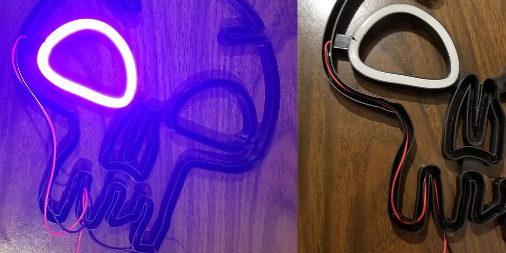 This image shows one of the LED strips hooked up to power for testing and shows the wires being passed through the 3D printed light shell.