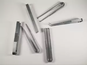 The next entry in the 3D printed tools list is actually a collection of 6 3D print tools. Shown in the photo is a set of tweezers with varying tips on them.