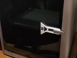 This scraper that attaches to your printer's door, shown in the photo, is one of the most handy Bambu Lab X1 Carbon upgrades! It keeps the scraper within reach while having a dedicated home.