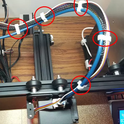 Shown in this photo are a couple of bowden tube cable clips installed on an Ender 3 Pro. These are some of the many cable management Ender 3 upgrades you can make to keep your printer's cables all tidy.