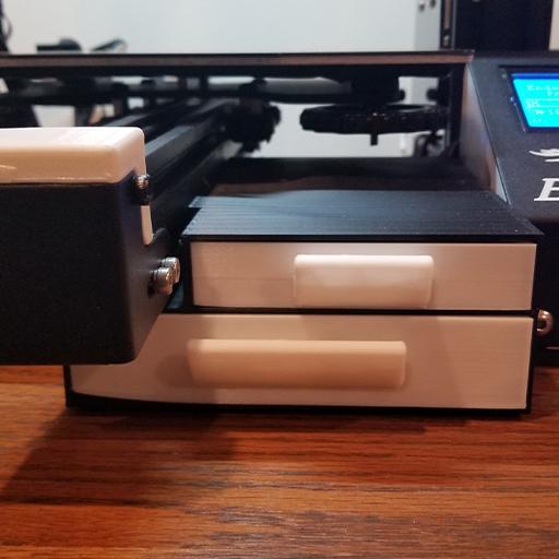 One of the coolest Ender 3 upgrades is this dual drawer print shown in the photo. The shell is printed in black PLA and the drawers are printed in off-white PLA. All of your Ender 3 spare parts and tools fit inside this awesome Ender 3 upgrade.