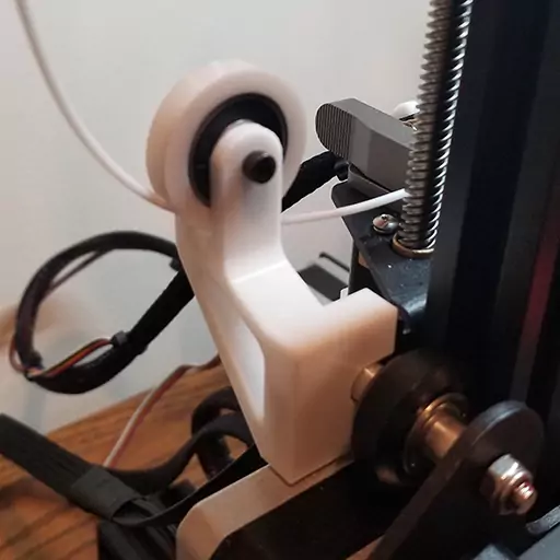 One of the best Ender 3 upgrades for added functionality is a filament guide. Shown here is the filament guide with filament running through it. This guide helps to put less strain on the filament, which could result in the filament snapping.