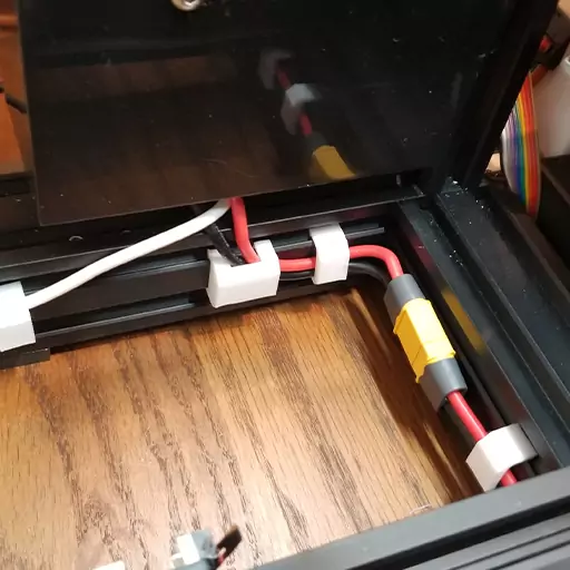Shown in this photo are a couple of power cable clips installed on an Ender 3 Pro. These are some of the many cable management Ender 3 upgrades you can make to keep your printer's cables all tidy.
