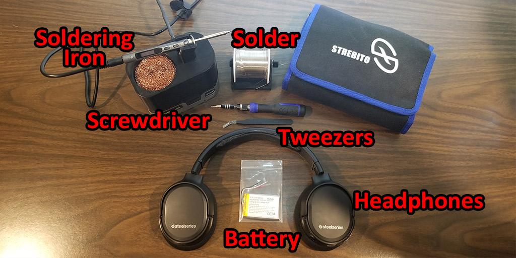 This photo shows the Arctis 1 wireless headset along with all the tools and parts needed to preform the Arctis 1 Wireless battery replacement. The tools and parts shown are a soldering iron, solder, a screwdriver, a pair of tweezers and the Arctis 1 replacement battery.
